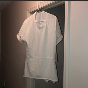 White blouse with gold accents.